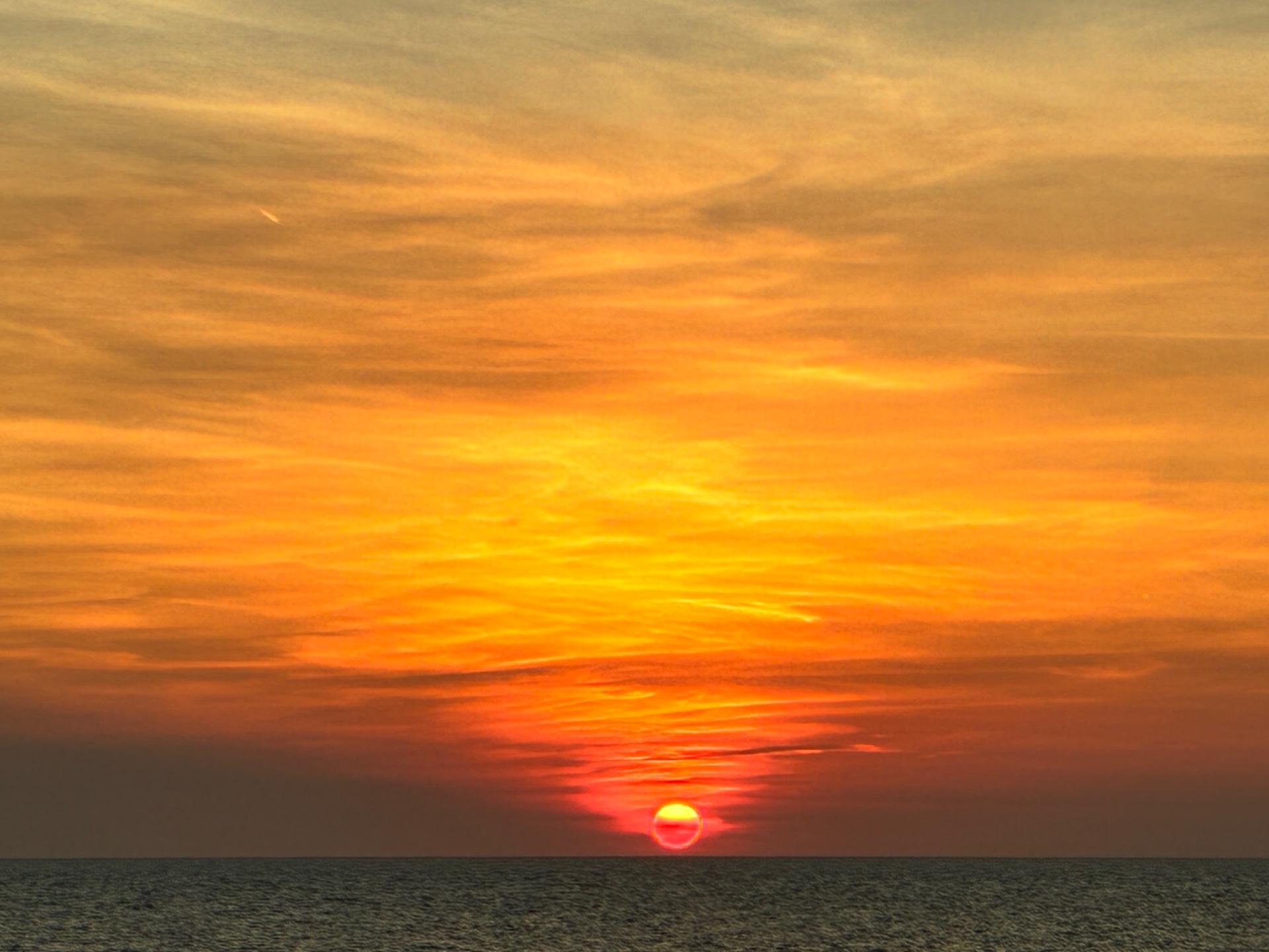The Coastal Edit — golden sunset over the water